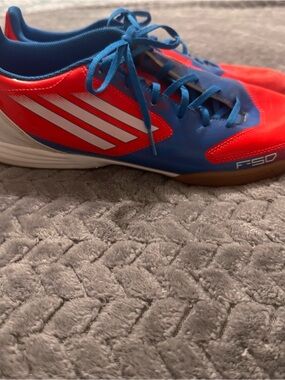 Mens Adidas f50 Indoor Soccer shoes in blue and orange.